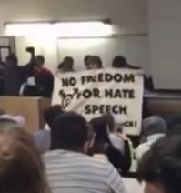 Students in
                  Toronto for Trans madness against Professor Peterson
                  claiming on a banner: "No freedom for hate
                  speech"