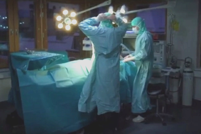 Surgeon with assistant at the operating
                  table (actors)