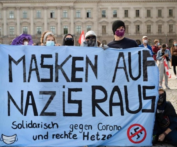 Cr. Antifa at Berlin invents
                    that all rejecting masks should be
                    "Nazis": Demo for corona terrorism with
                    banner: "Masks on - Nazis out"
                    ("Masken auf - Nazis raus" - Aug 9, 2020