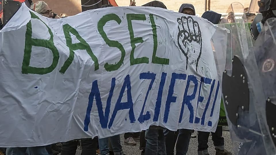 Criminal Antifa in Basel with the banner
                      "Basel Nazi-free" ("Basel
                      nazifrei!") with the communist Antifa fist