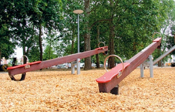 Seesaw made of wood with soft
                                rubber buffers on a sawdust surface,
                                Claramatte-Park (Clara Meadow Park),
                                Basel, Switzerland